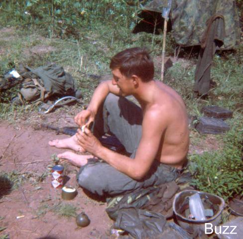Me having breakfast after a rainy night on an ambush near Ben Chua, Vietnam.