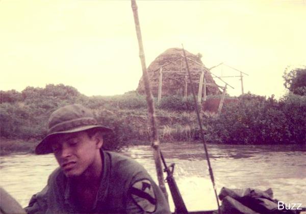 Lopez in skiff (river boats) on Saigon river near Ben Chua, Vietnam.